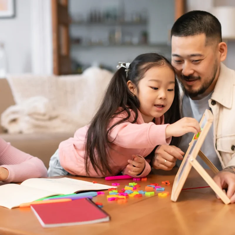 child-learning-with-her-parents-at-home-2026-01-08-23-03-32-utc